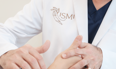 Doctor performing a physical exam of a woman forearm at ISMI Montreal