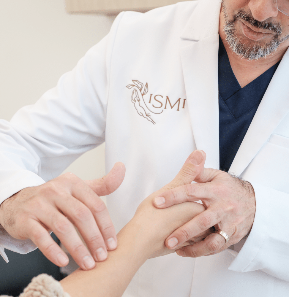 Doctor performing a physical exam of a woman forearm at ISMI Montreal